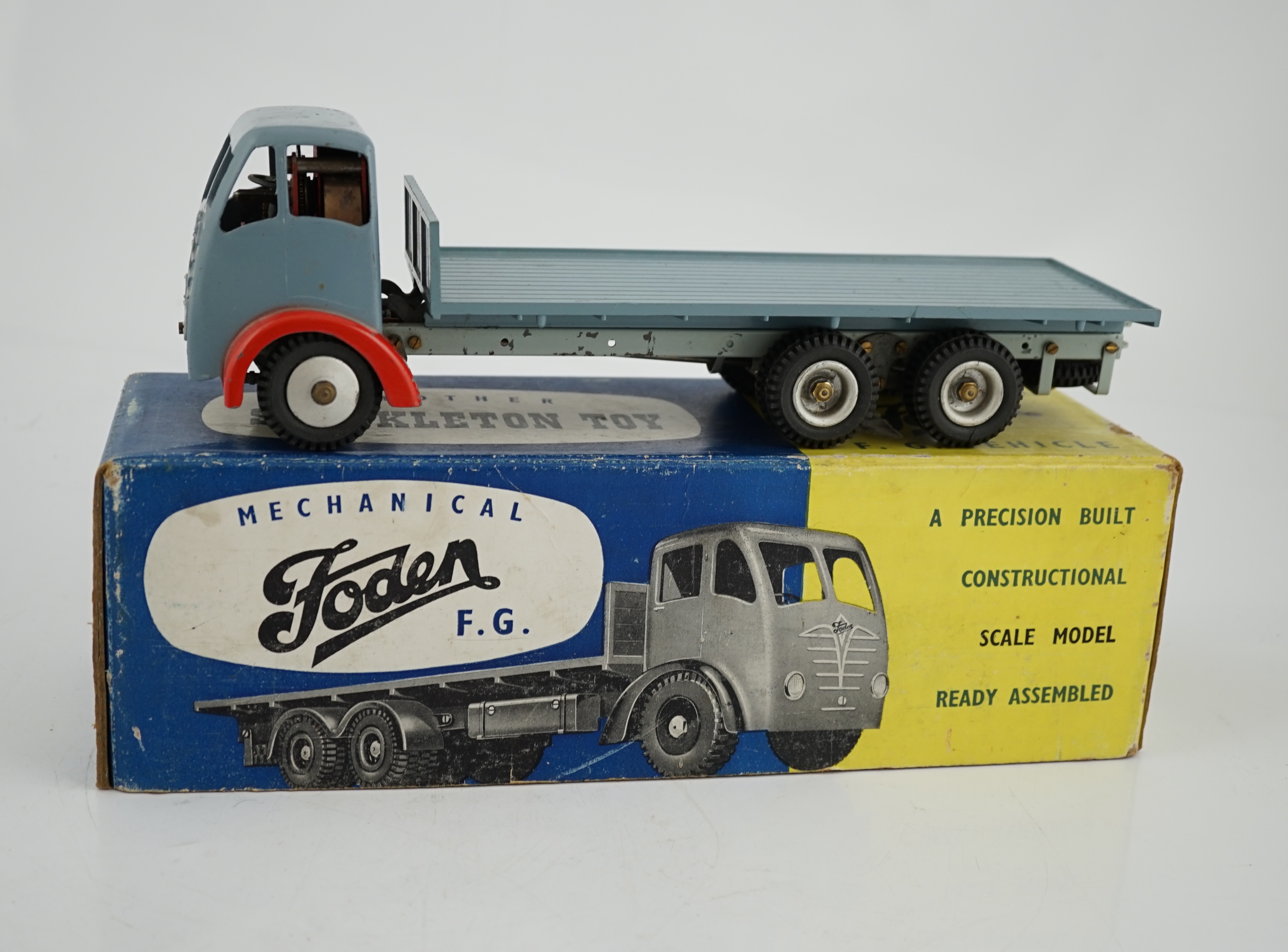 A boxed Shackleton Toy Foden FG flatbed lorry in smoke grey, with both keys, in the correct colour coded box